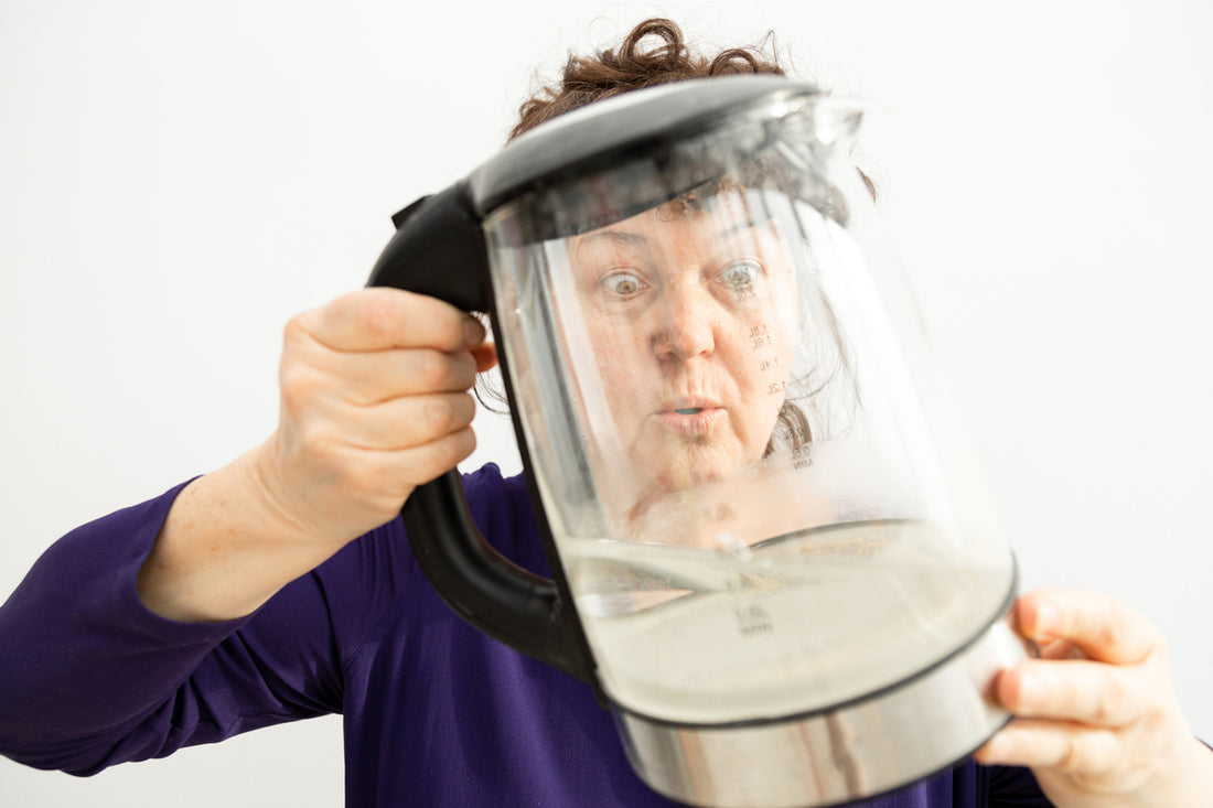 Lady looking inside an empty kettle