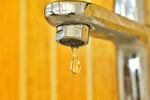 Filtered water flowing from a modern kitchen tap