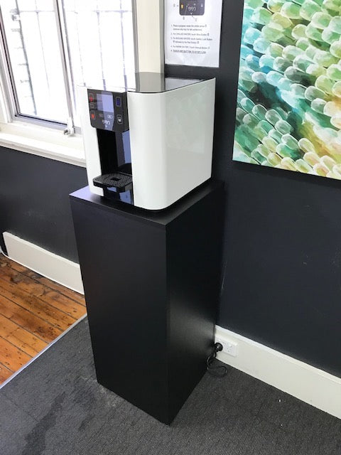 Black BIBO Water Bar Pedestal with sleek modern design in Office 